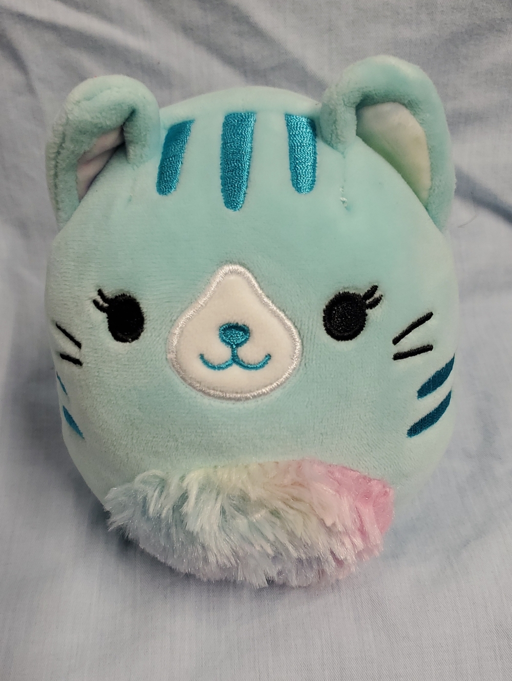 Squishmallows Mint Blue Cat Plush with Pastel Rainbow Puff